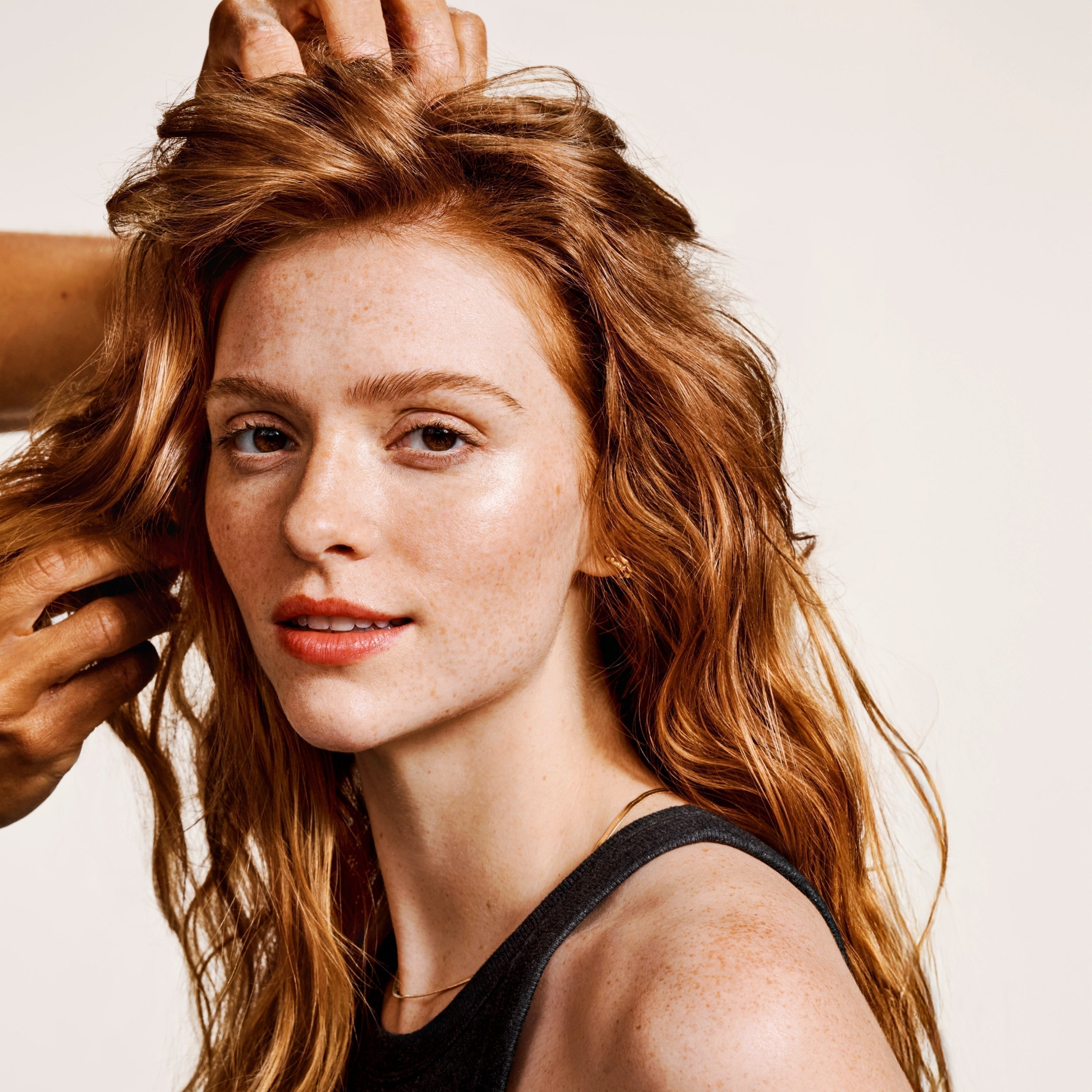 Woman with red hair having her hair styled