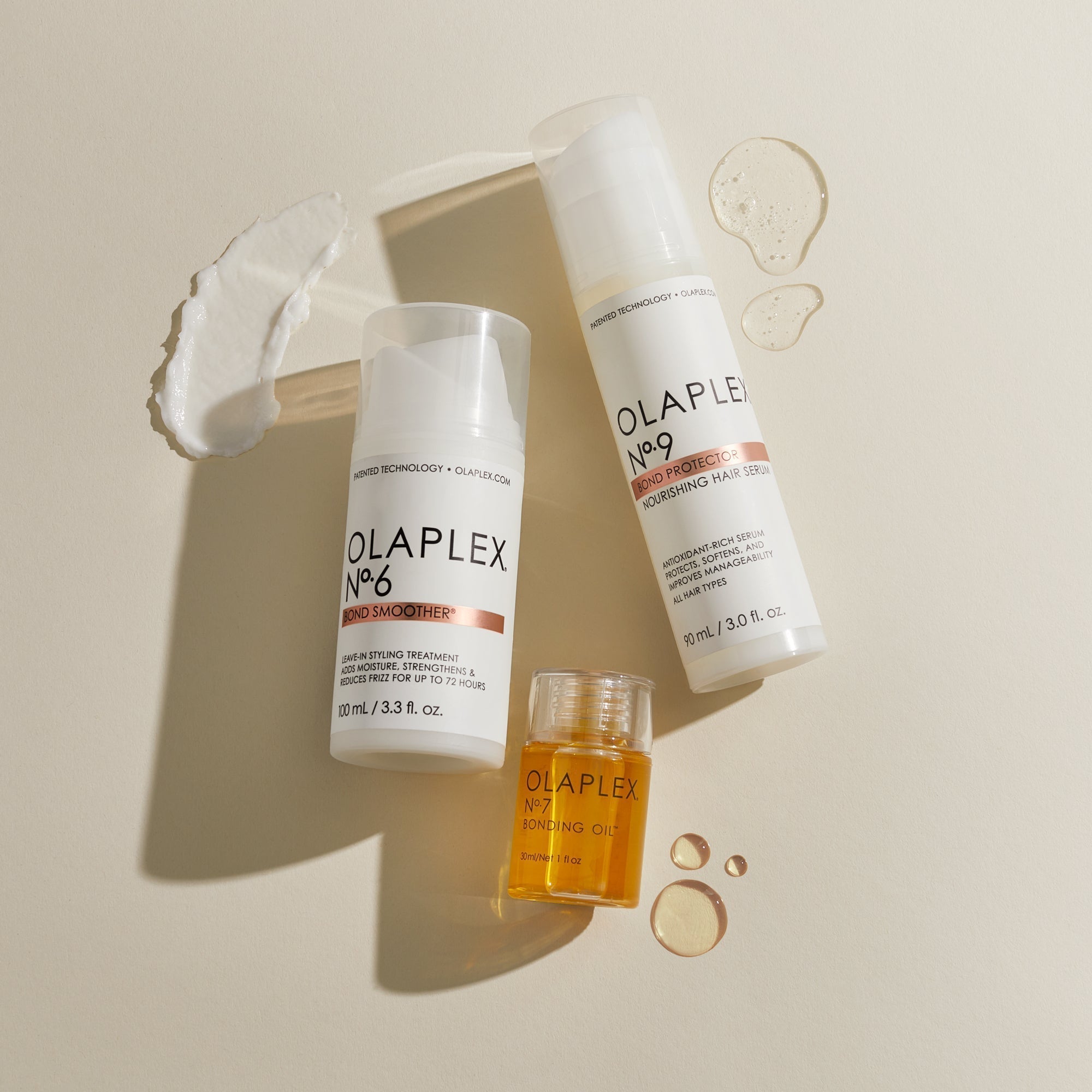 A flatlay of No.6, No.9, and No.3 with smears and drops of the products surrounding the bottles 