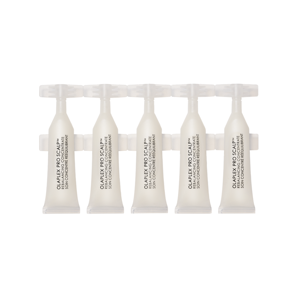 Set of five white hair care products in small, individual ampoules or vials, arranged in a row against a black and grey checkered background.

PRO SCALP™ REBALANCING CONCENTRATE - main view
