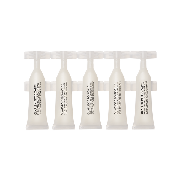 Set of five white hair care products in small, individual ampoules or vials, arranged in a row against a black and grey checkered background.

PRO SCALP™ REBALANCING CONCENTRATE - main view